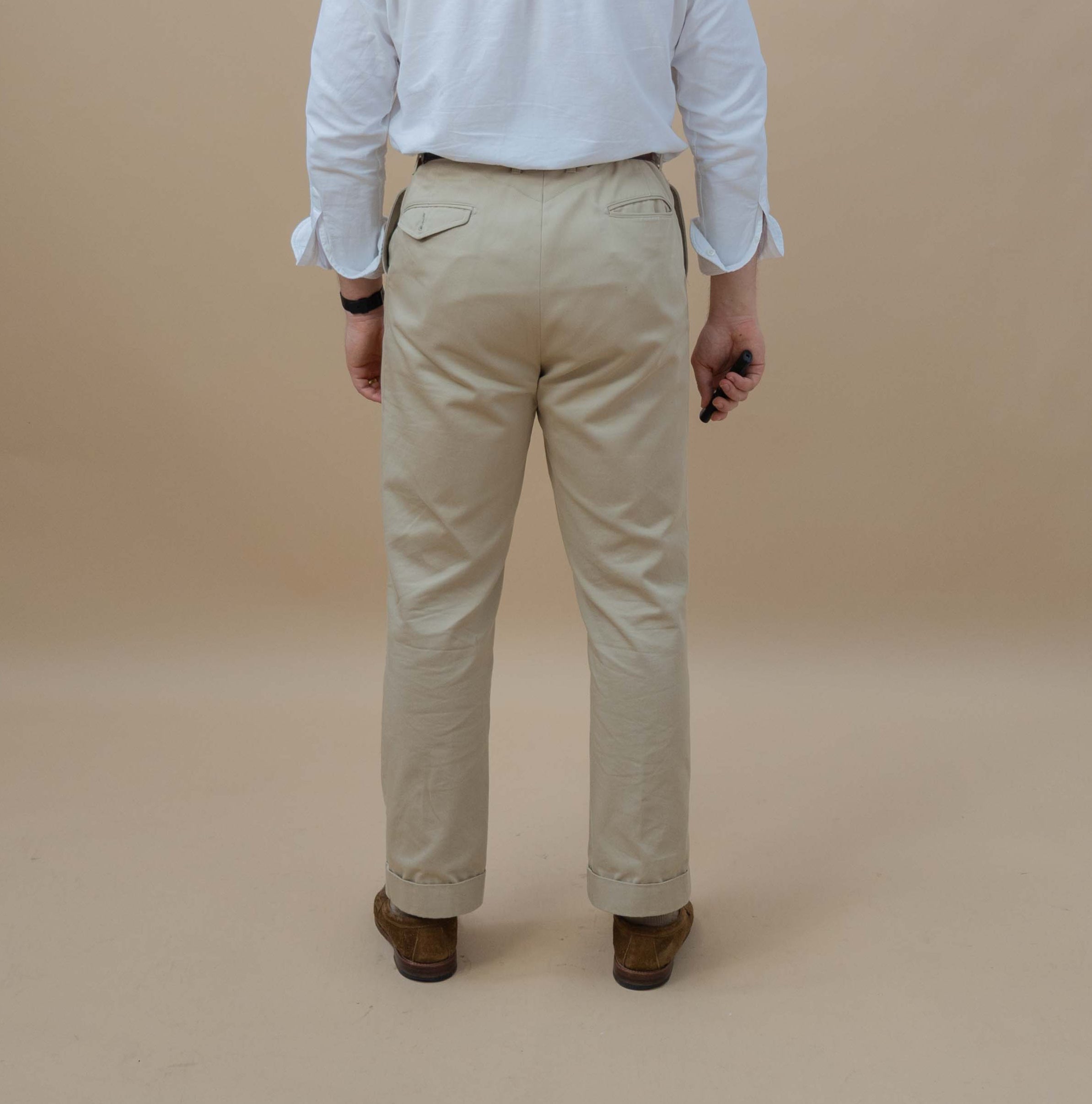 man wearing chinos facing away