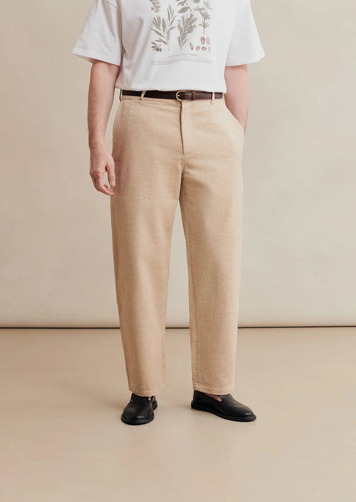 Undyed cotton and linen balloon trousers with corduroy texture from De Bonne Facture, featuring a relaxed fit and natural fabric look.