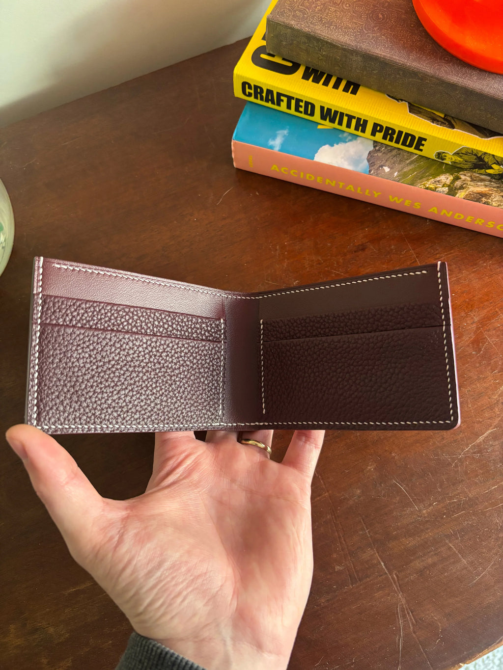 Bronson Leatherworks Bull-Calf Billfold in Rouge Sellier showcasing a compact leather wallet with fine stitching and classic design.