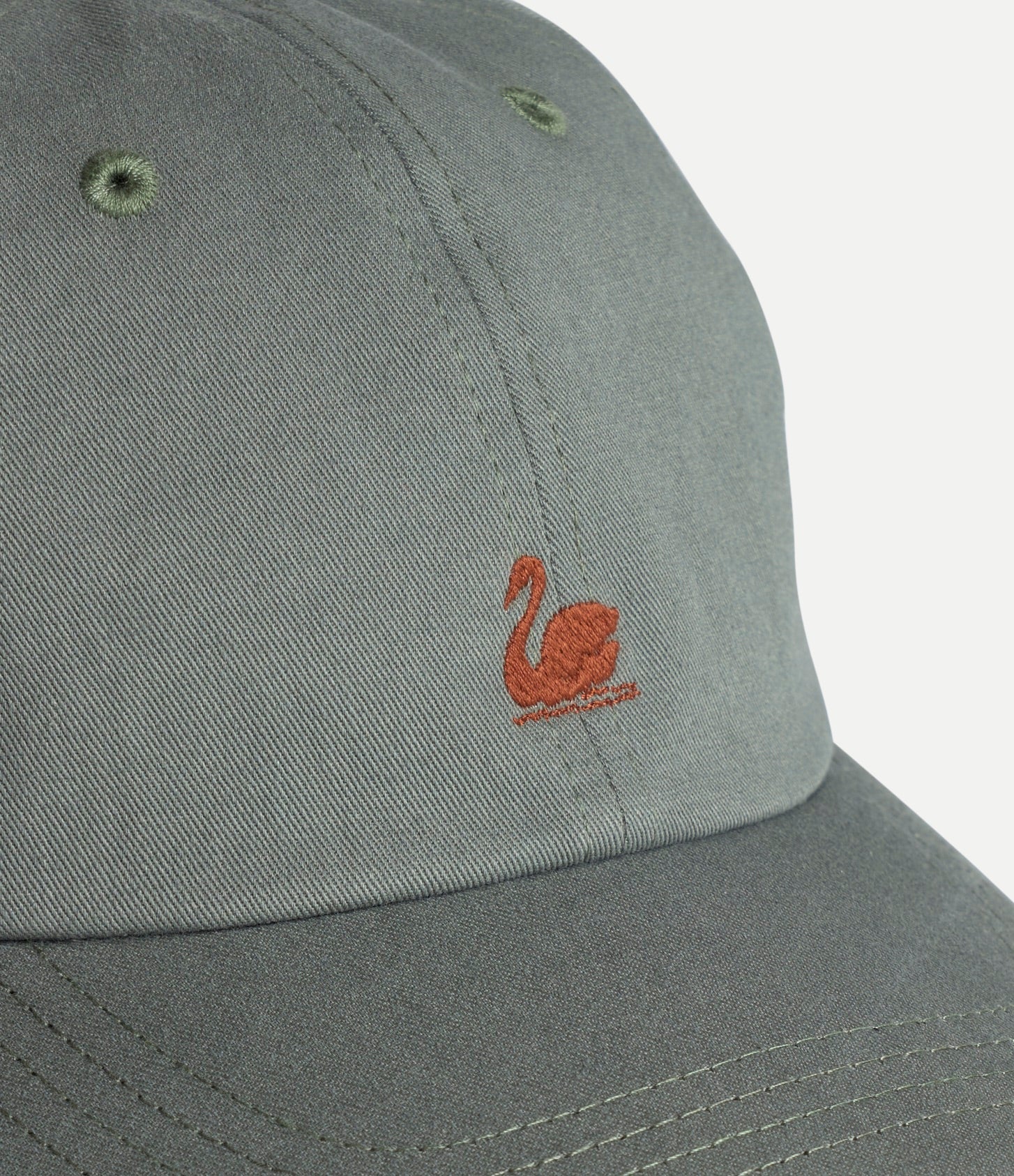 Light army cotton twill cap with Merz b Schwanen swan logo, classic accessory with adjustable strap and curved brim.
