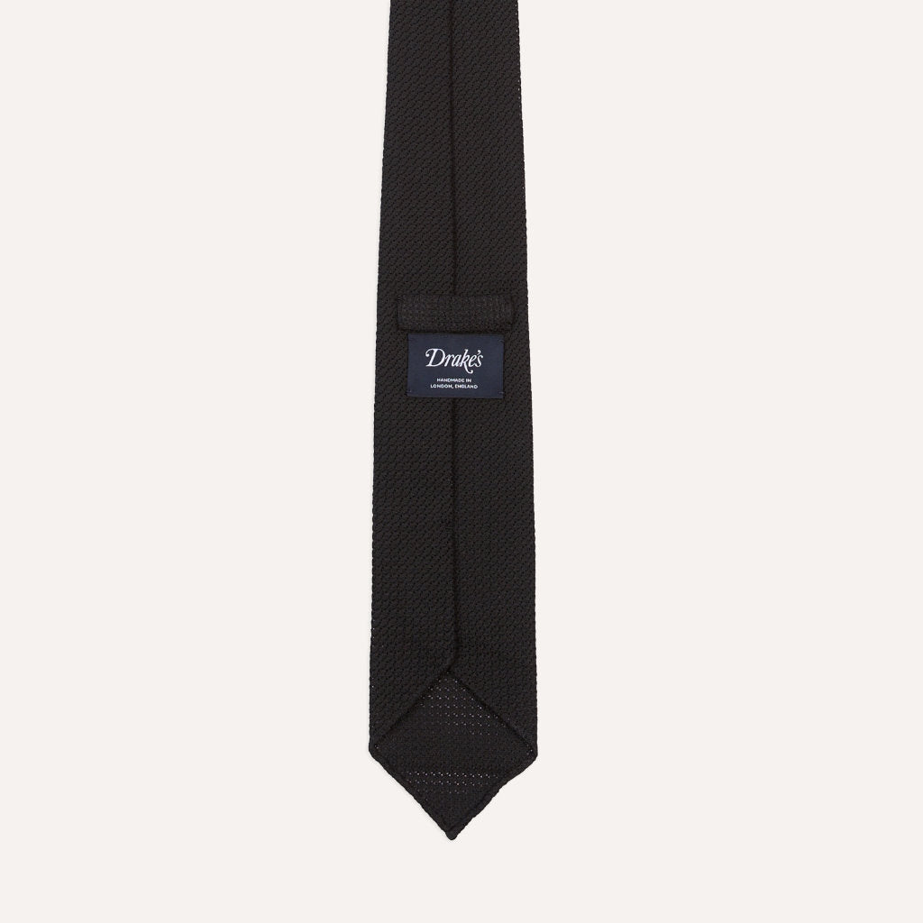 Black large knot Grenadine handrolled tie by Drake's, showcasing its textured fabric and classic design for formal accessories.