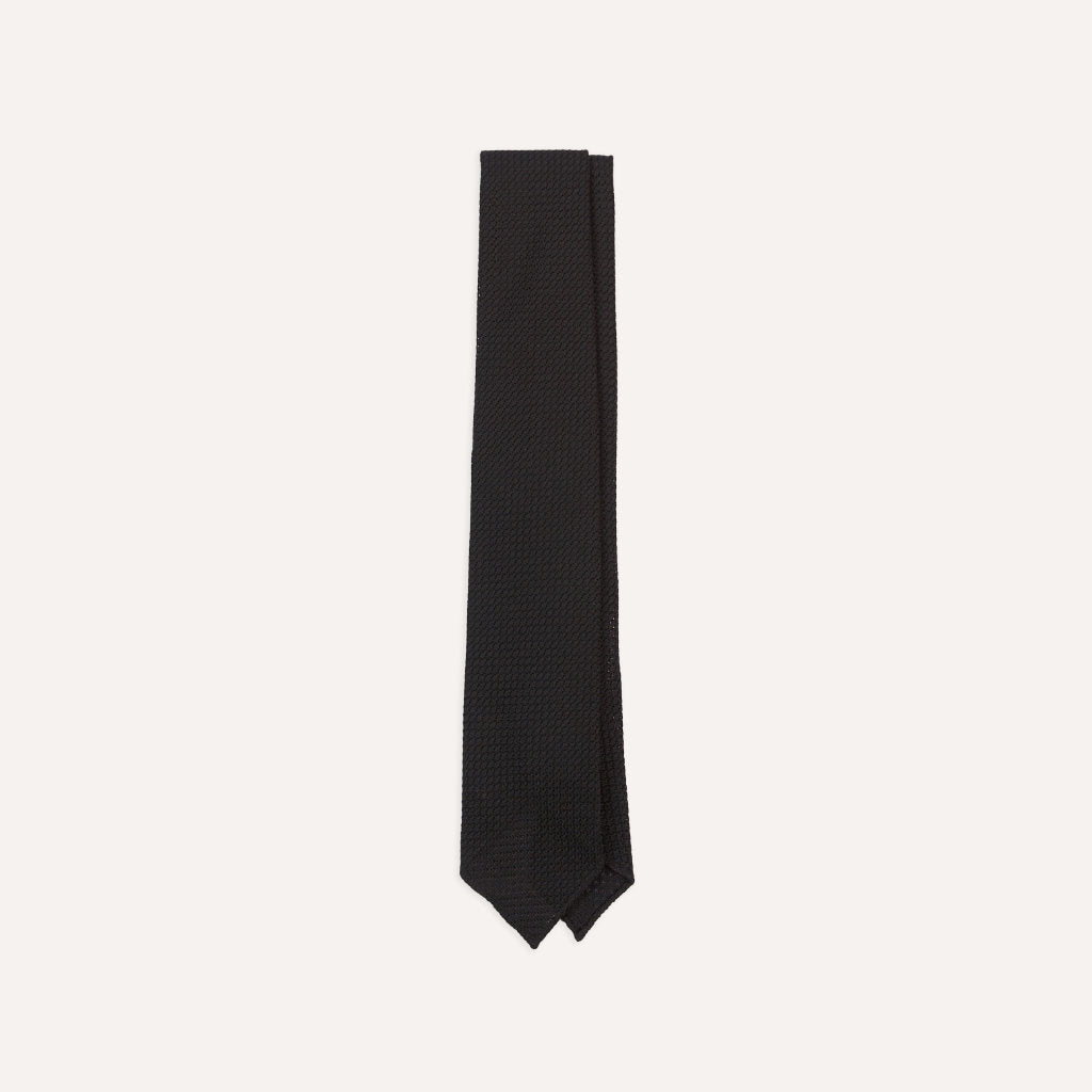 Black large knot Grenadine handrolled tie by Drake's, shown draped neatly for a sophisticated accessories look.