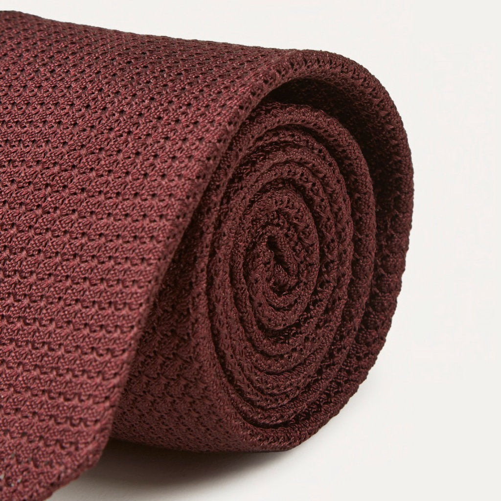 Large knot Grenadine handrolled tie in wine color by Drake's, featuring a textured fabric and classic design for formal accessories.