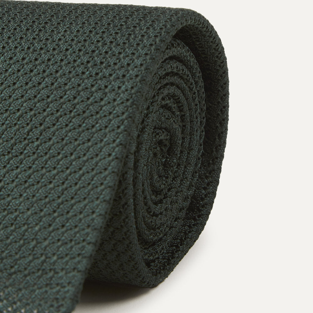 Green large knot Grenadine handrolled tie by Drake's, featuring a classic textured pattern, styled as an elegant accessory.