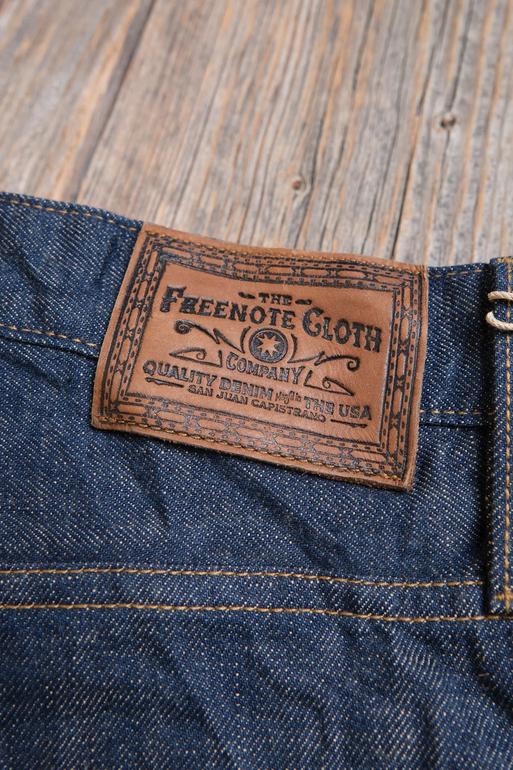 Freenote Belford Straight 13 oz rinsed denim jeans, showcasing classic fit and deep blue wash with visible stitching details.