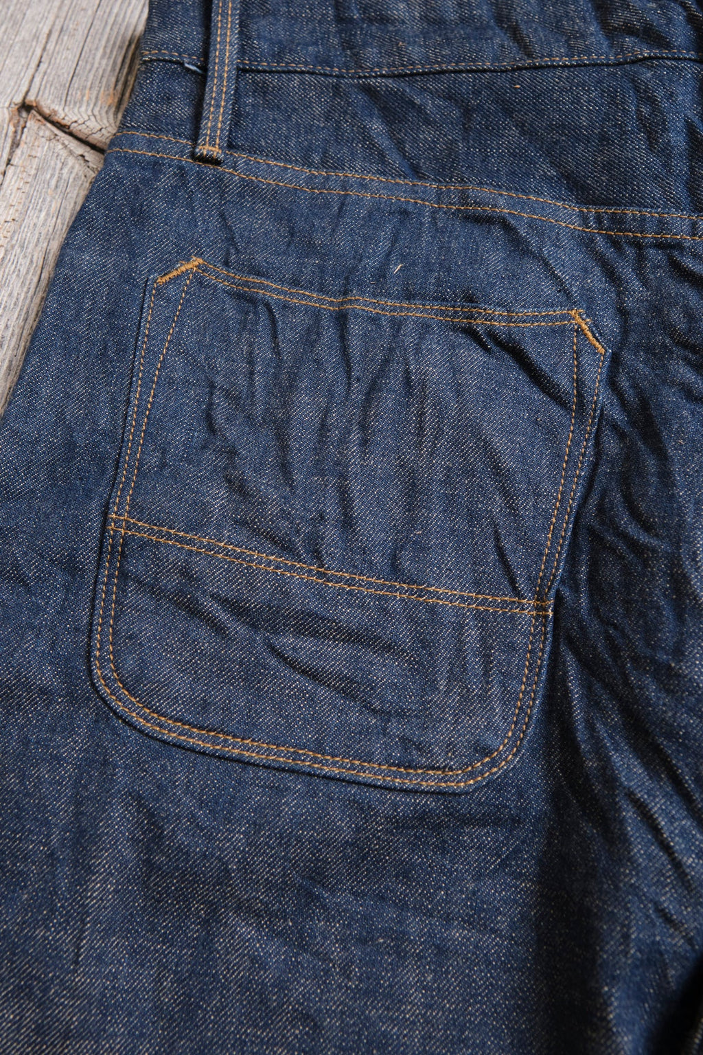 Freenote Belford Straight 13-ounce rinsed denim jeans, with a classic fit and visible stitching, displayed on a hanger.