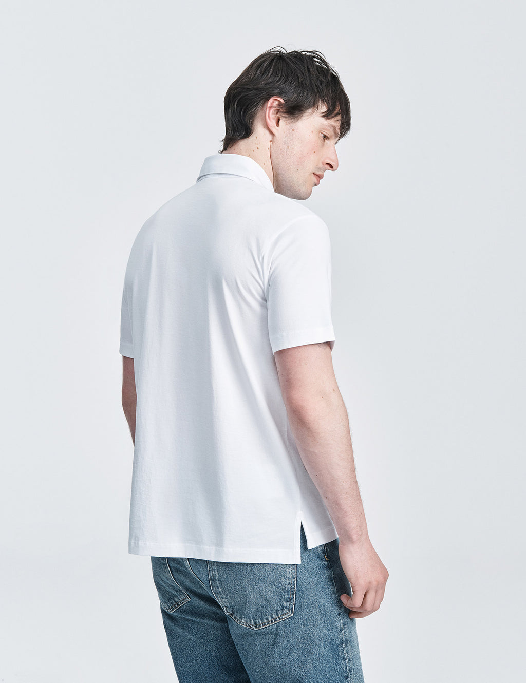 White spread collar jersey polo shirt by håndværk, showing the classic collar and soft fabric detail.