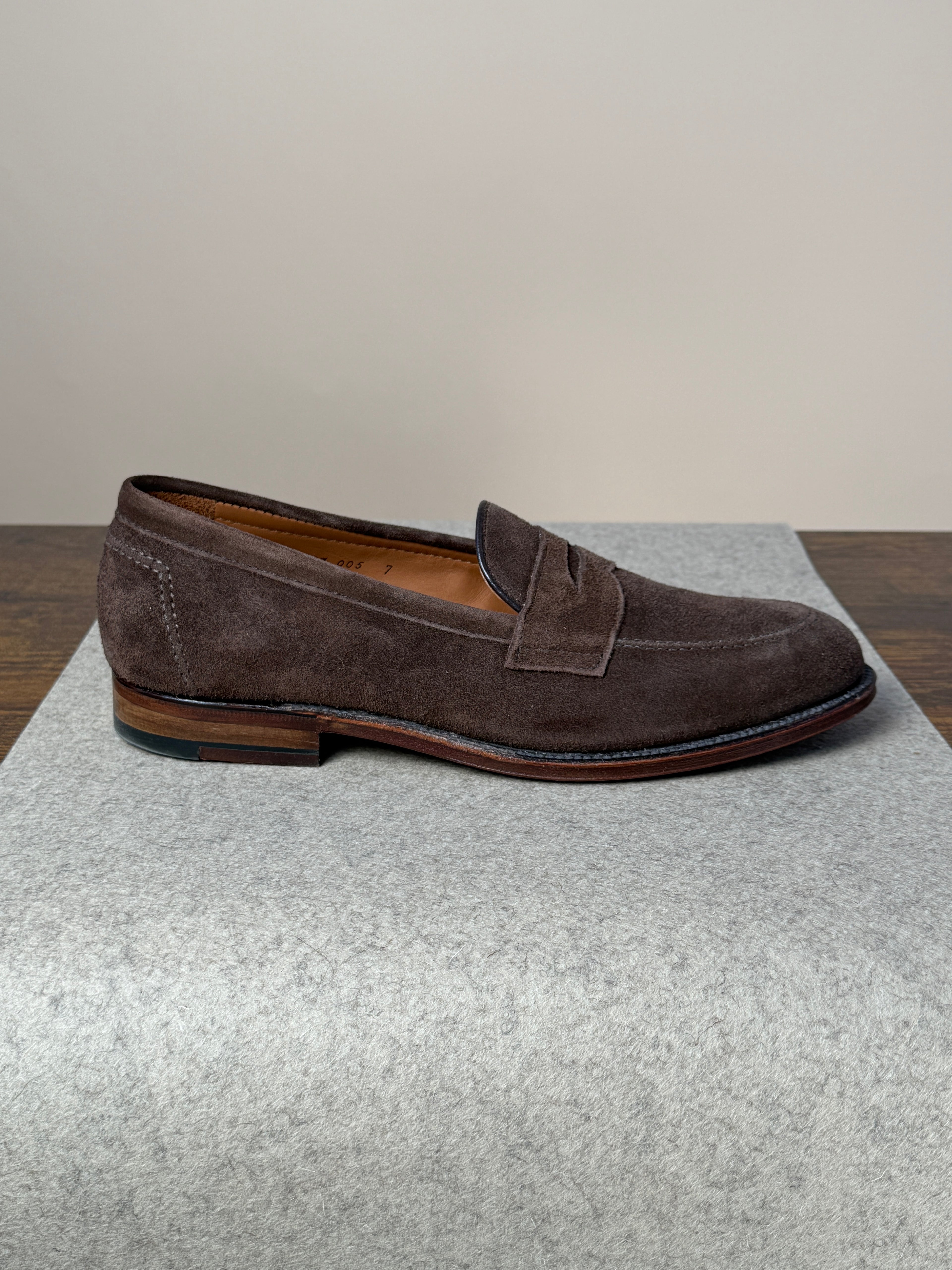 Alden Copley Penny Loafer in dark brown suede, featuring classic slip-on design and sleek stitching, on a neutral background.