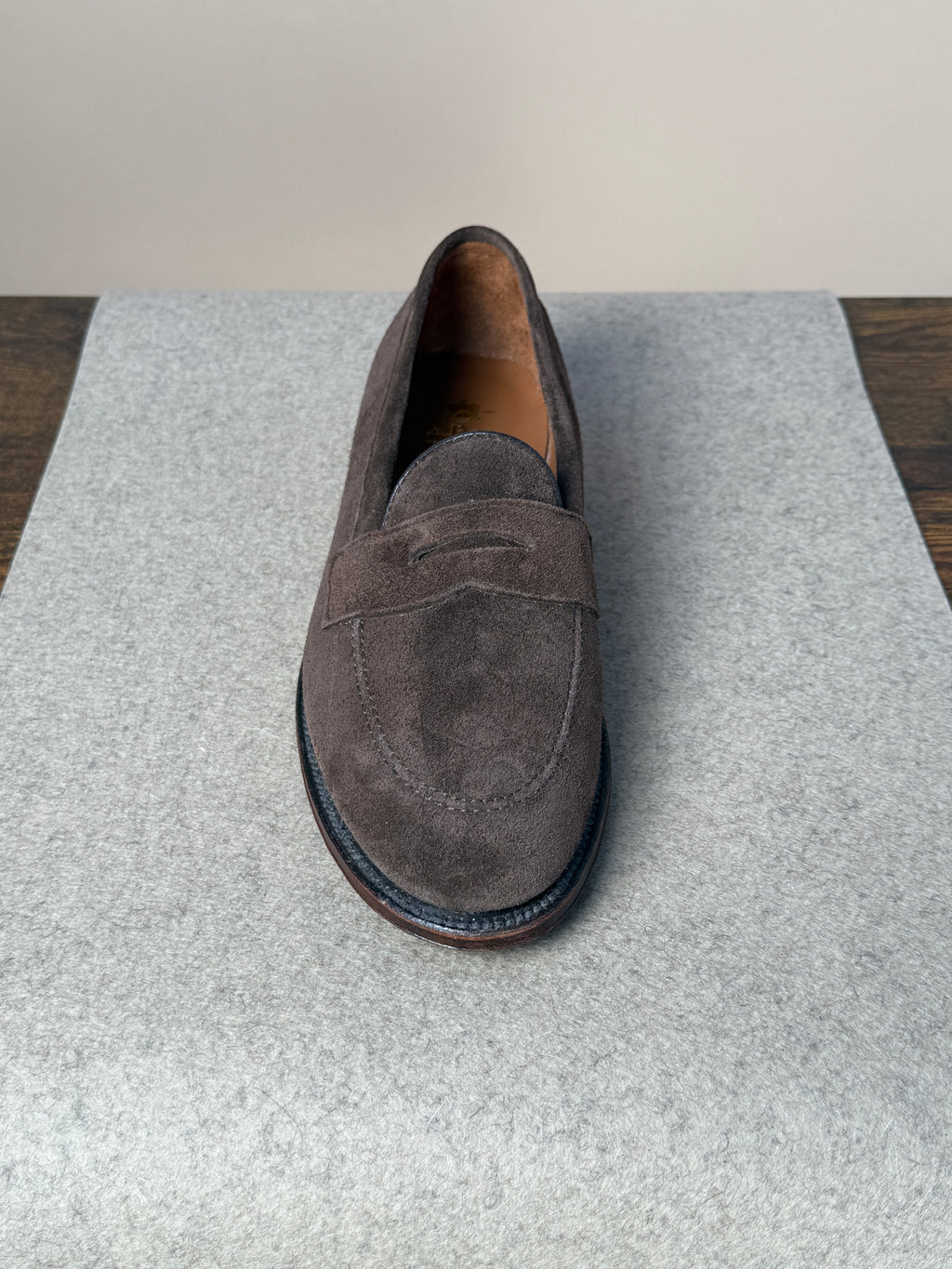 Alden Copley Penny Loafer in dark brown suede, showing classic slip-on footwear with a smooth suede finish and penny strap detail.