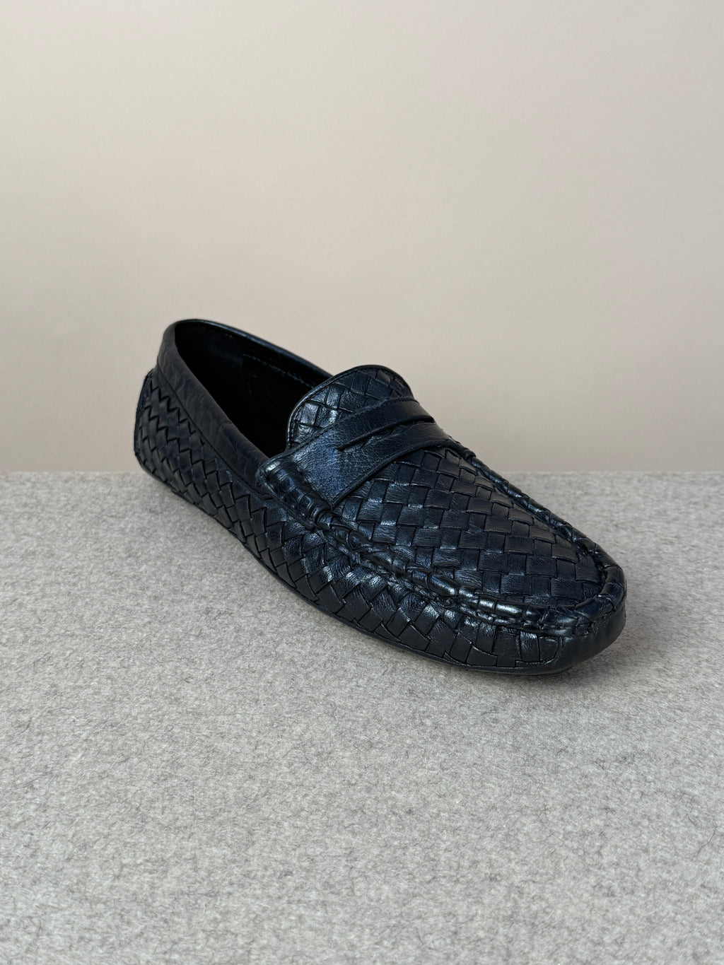 Black woven driving loafer by Mario Bemer, showcasing stylish leather footwear designed for comfort and classic elegance.