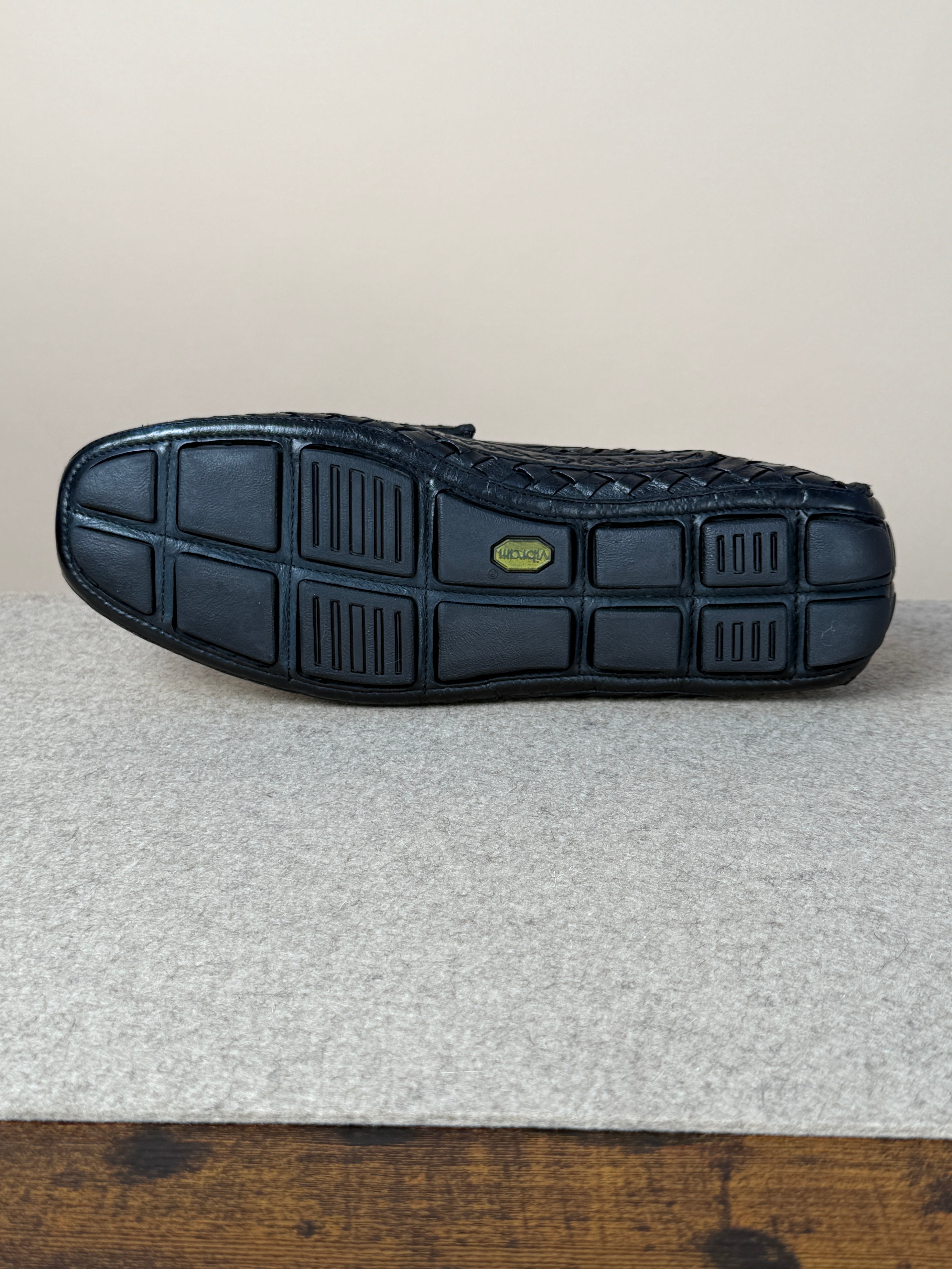 Black woven driving loafer by Mario Bemer, showcasing stylish slip-on footwear with intricate woven detailing and a comfortable sole.