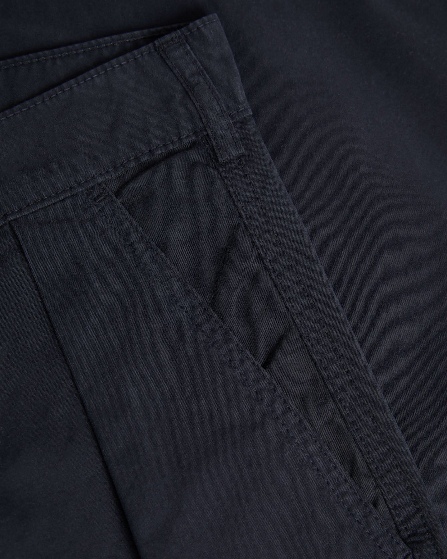 Dark navy Lapa Canvas Pleated Shorts by La Paz, showing the relaxed fit and pleated design on the front.