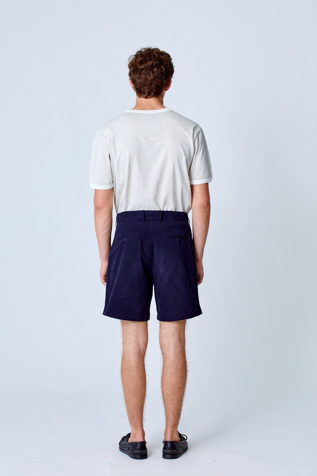 Dark navy Lapa Canvas Pleated Shorts by La Paz, shown laid flat with front view, highlighting pleats and lightweight fabric.