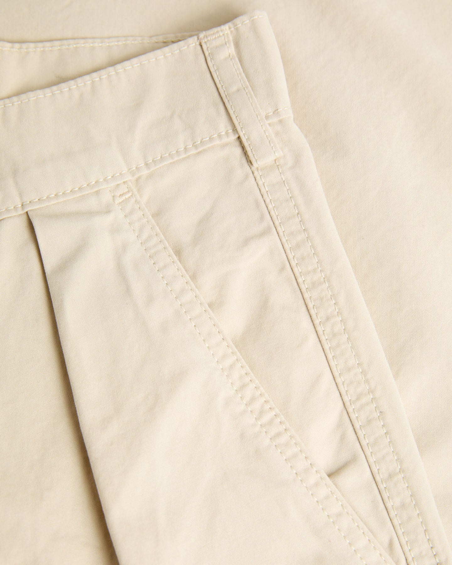 Cream Lapa Canvas Pleated Shorts by La Paz, showing the lightweight, pleated design and comfortable fit on a model.