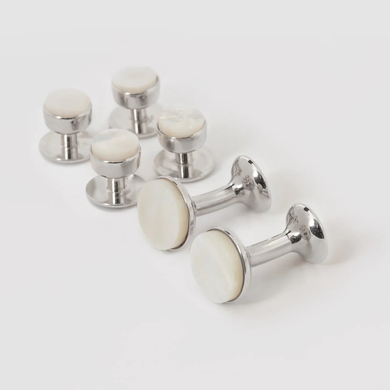 Mother of Pearl bow stud earrings set by Codis Maya featuring rhodium-plated silver accessories with elegant bow designs.