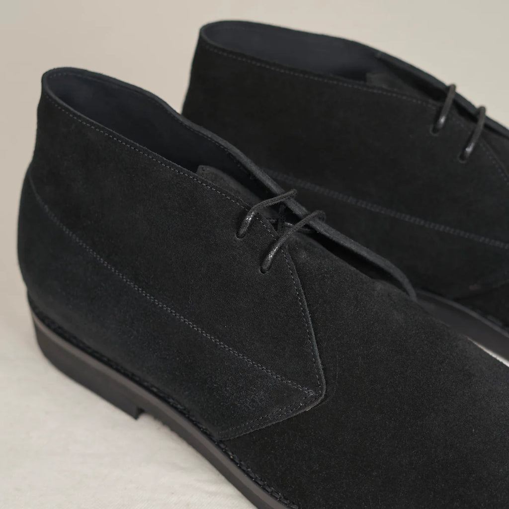 Black suede Voyager Chukka boots by August Special, showcasing a stylish ankle-high footwear design with laced closure.