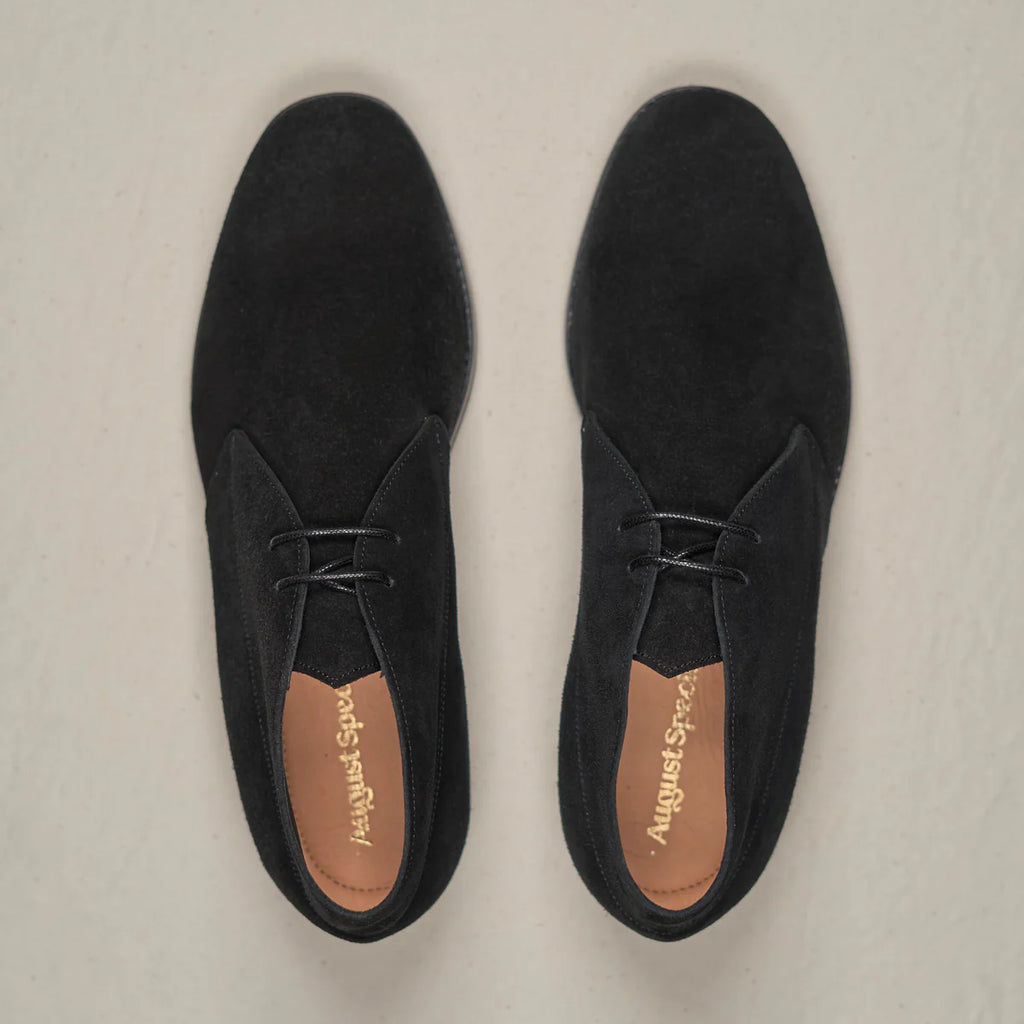 Black suede Voyager Chukka footwear by August Special, featuring a classic ankle-high design with durable laces and stylish stitching.