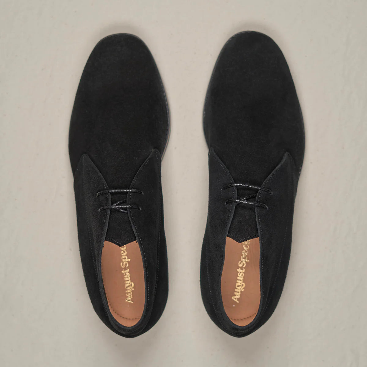 Black suede Voyager Chukka footwear by August Special, featuring a classic ankle-high design with durable laces and stylish stitching.