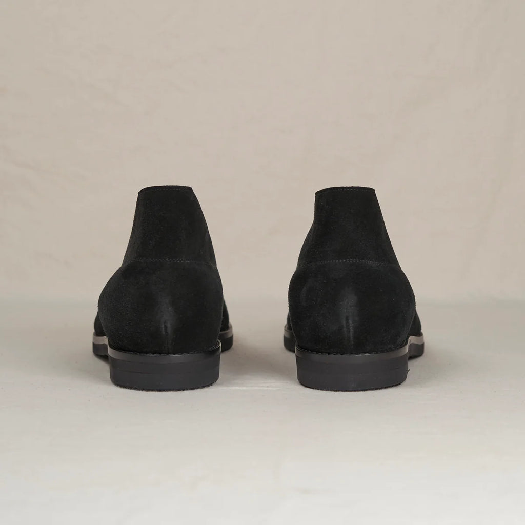 Black suede Voyager Chukka boots by August Special, featuring a classic ankle-height design and stylish laces.