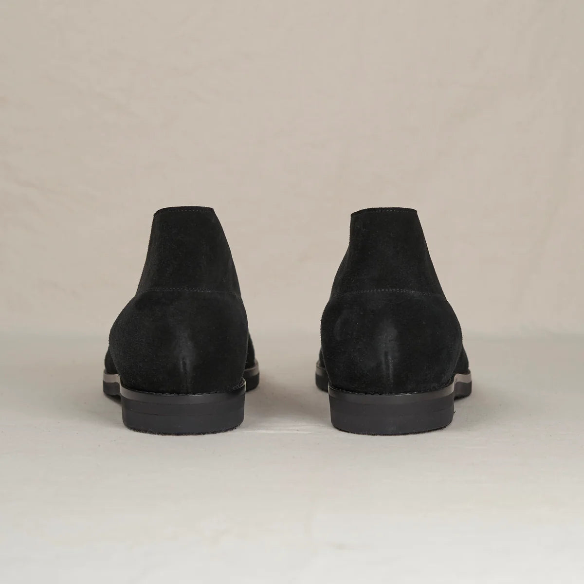 Black suede Voyager Chukka boots by August Special, featuring a classic ankle-height design and stylish laces.