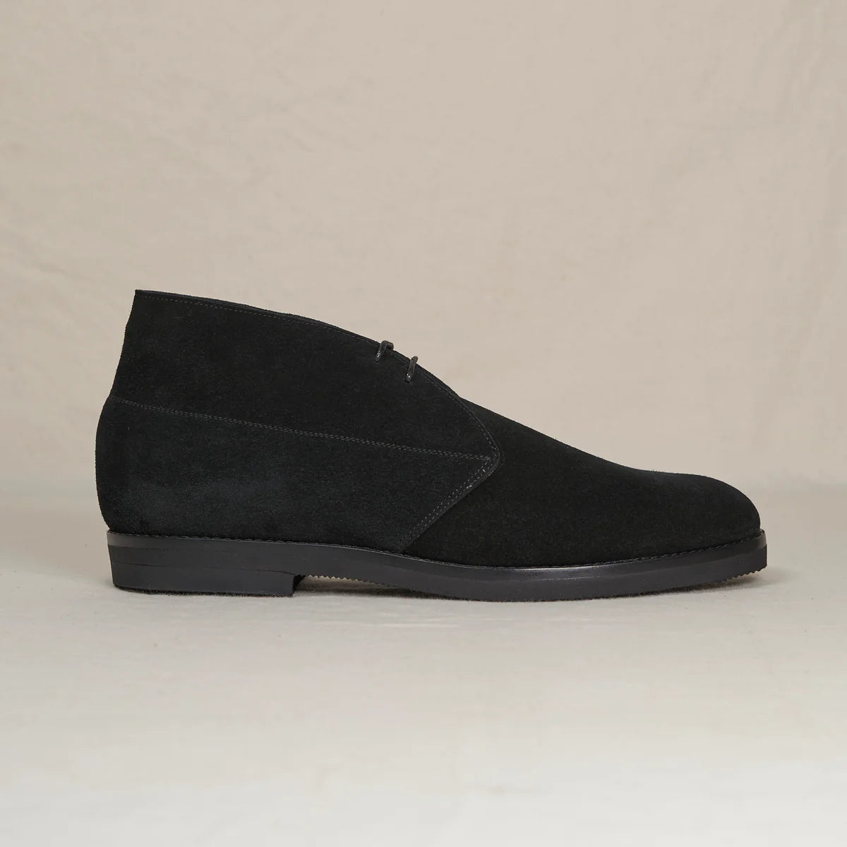 Black suede Voyager Chukka boots by August Special, showcasing the stylish ankle-height footwear with sleek design and textured suede finish.