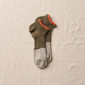 Olive linen sneaker socks by YAHAE displayed on a foot, showcasing breathable fabric and comfortable fit for casual wear.