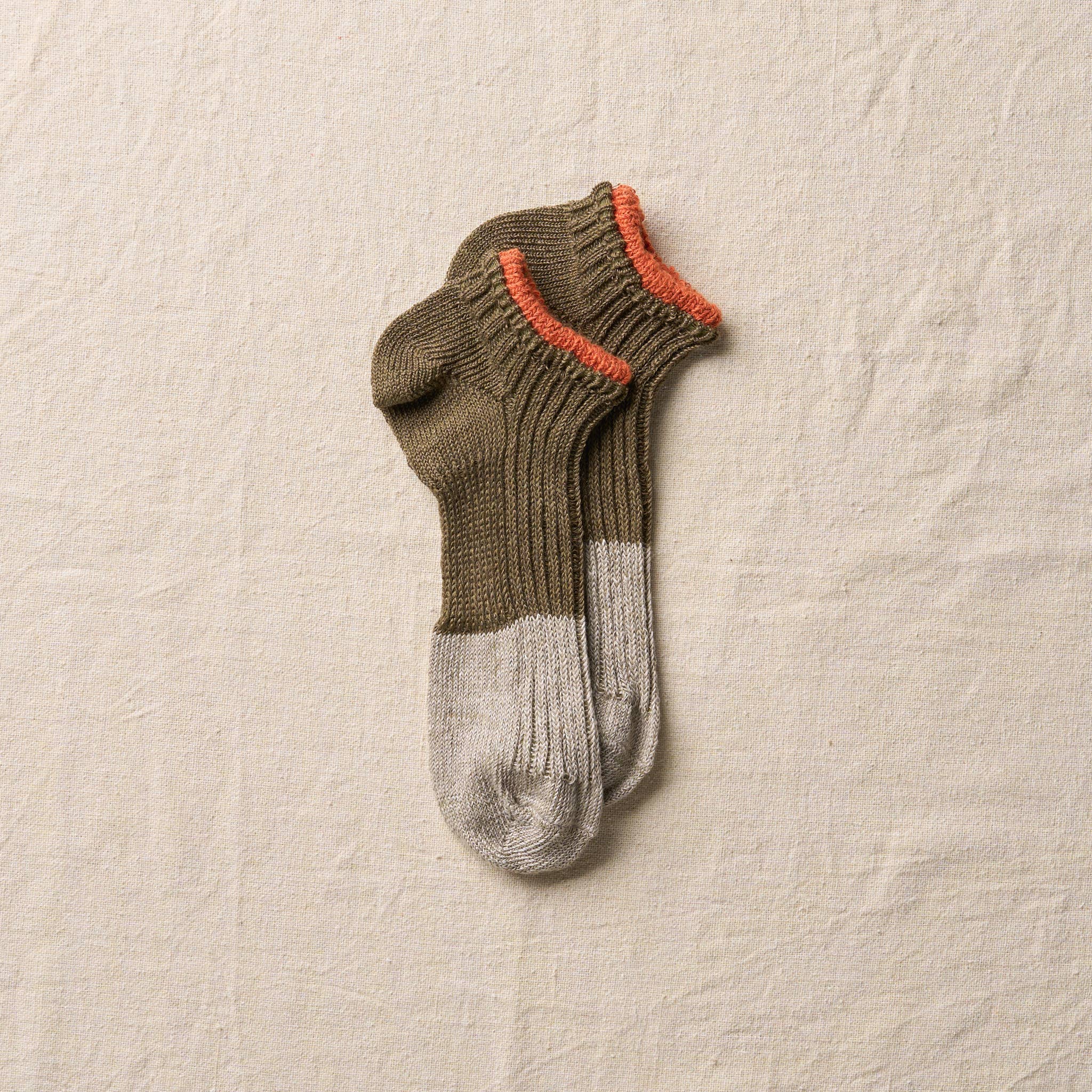 Yahae olive linen sneaker socks displayed on a neutral background, showcasing their lightweight and breathable fabric design.