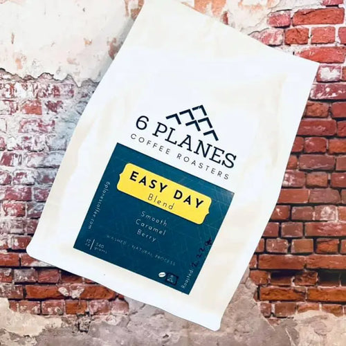 6 Planes Coffee Easy Day Blend 12oz whole bean coffee bag with label featuring colorful design and branding.
