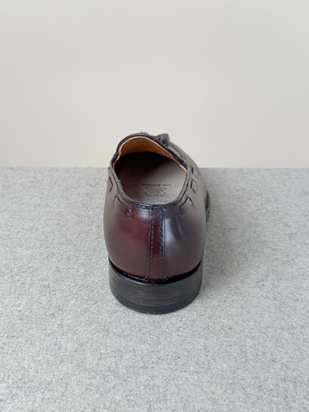 Dark brown calfskin tassel loafers by Alden, stylish men's footwear with decorative tassels and sleek leather finish.