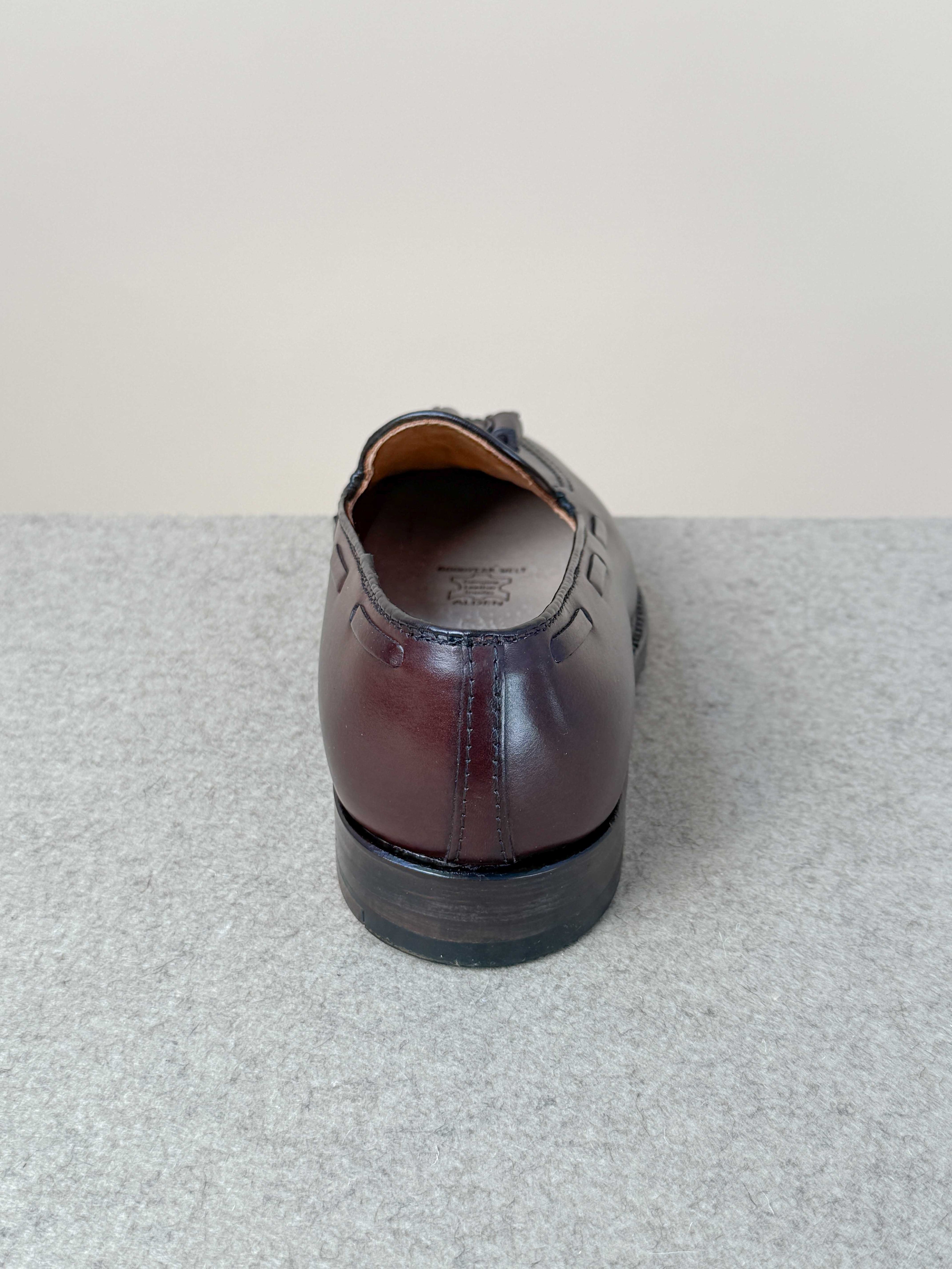 Dark brown calfskin tassel loafers by Alden, stylish men's footwear with decorative tassels and sleek leather finish.