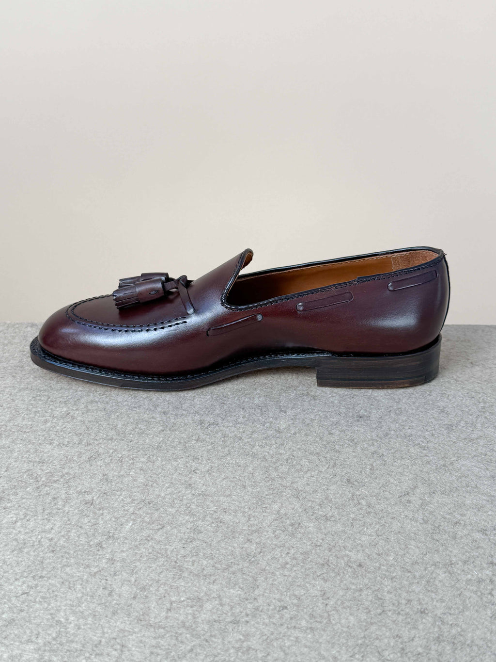 Dark brown calfskin tassel loafers by Alden, stylish men's footwear with classic tassel detailing and smooth leather finish.