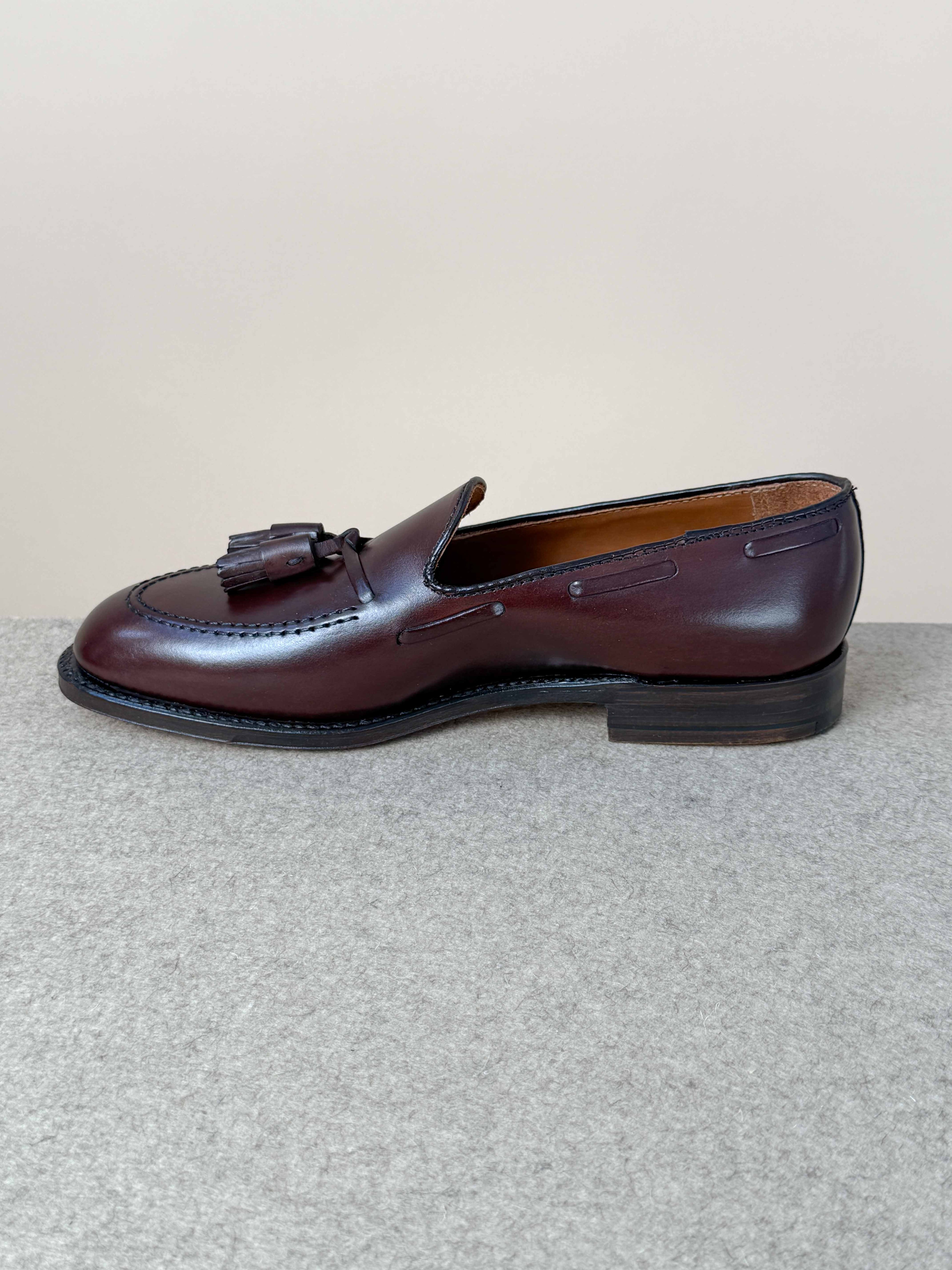 Dark brown calfskin tassel loafers by Alden, stylish men's footwear with classic tassel detailing and smooth leather finish.