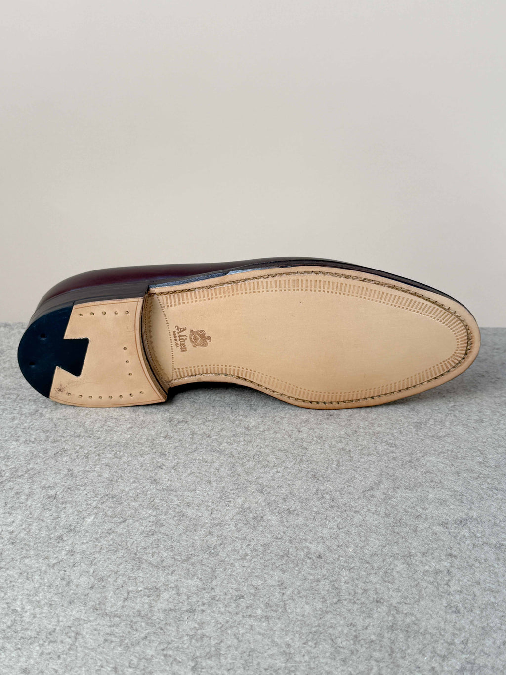 Dark brown calfskin tassel loafers by Alden, showcasing polished leather uppers and elegant tassel details on footwear.