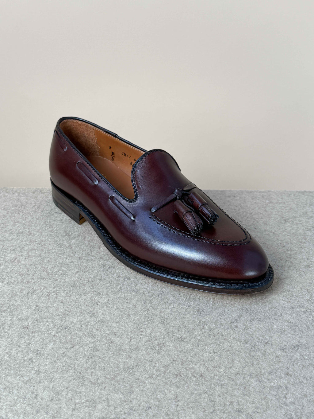Dark brown calfskin tassel loafers by Alden, showcasing sleek, classic men's footwear with detailed tassel accents.
