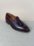 Dark brown calfskin tassel loafers by Alden, showcasing sleek, classic men's footwear with detailed tassel accents.