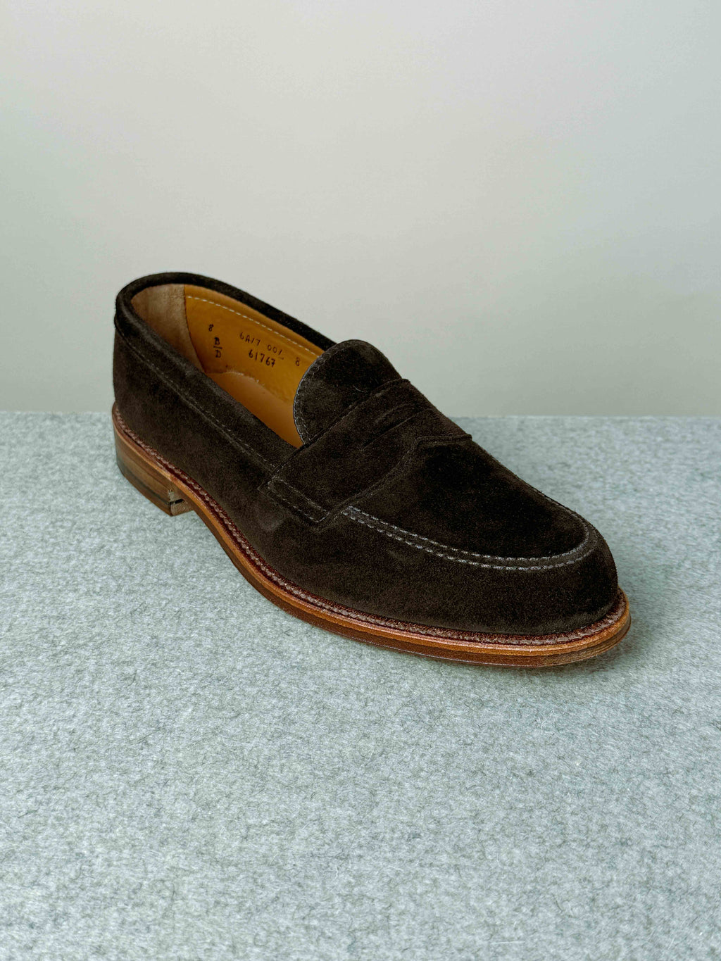 Alden Leisure Penny Loafer in chocolate suede, showing a close-up of the classic slip-on footwear with penny strap detail.