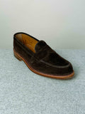 Alden Leisure Penny Loafer in chocolate suede, showing a close-up of the classic slip-on footwear with penny strap detail.