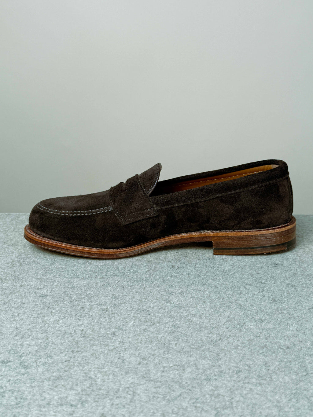 Alden Leisure Penny Loafer in rich chocolate suede, showcasing classic slip-on footwear with a sleek design and polished finish.