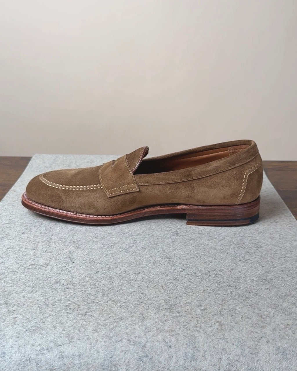 Alden Copley Penny Loafer in snuff suede, showcasing classic slip-on footwear with a sleek, polished design and tassel accents.