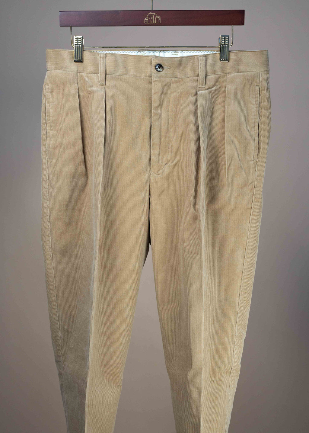Beige 2-pleat corduroy chinos by Barnstormer, casual men's clothing with front pleats and side pockets, shown flat.