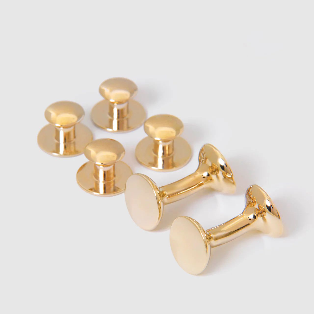 Gold Bow Stud Set by Codis Maya, elegant accessories featuring gold-tone bow-shaped earrings on a neutral background.