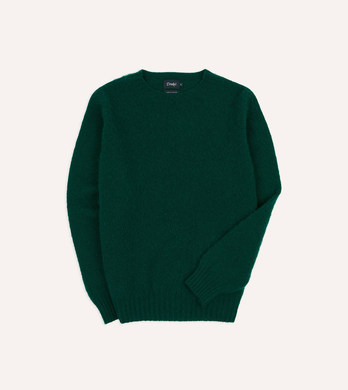 Drake's brushed Shetland wool crewneck sweater in forest green, showing close-up of textured knit fabric and classic fit.