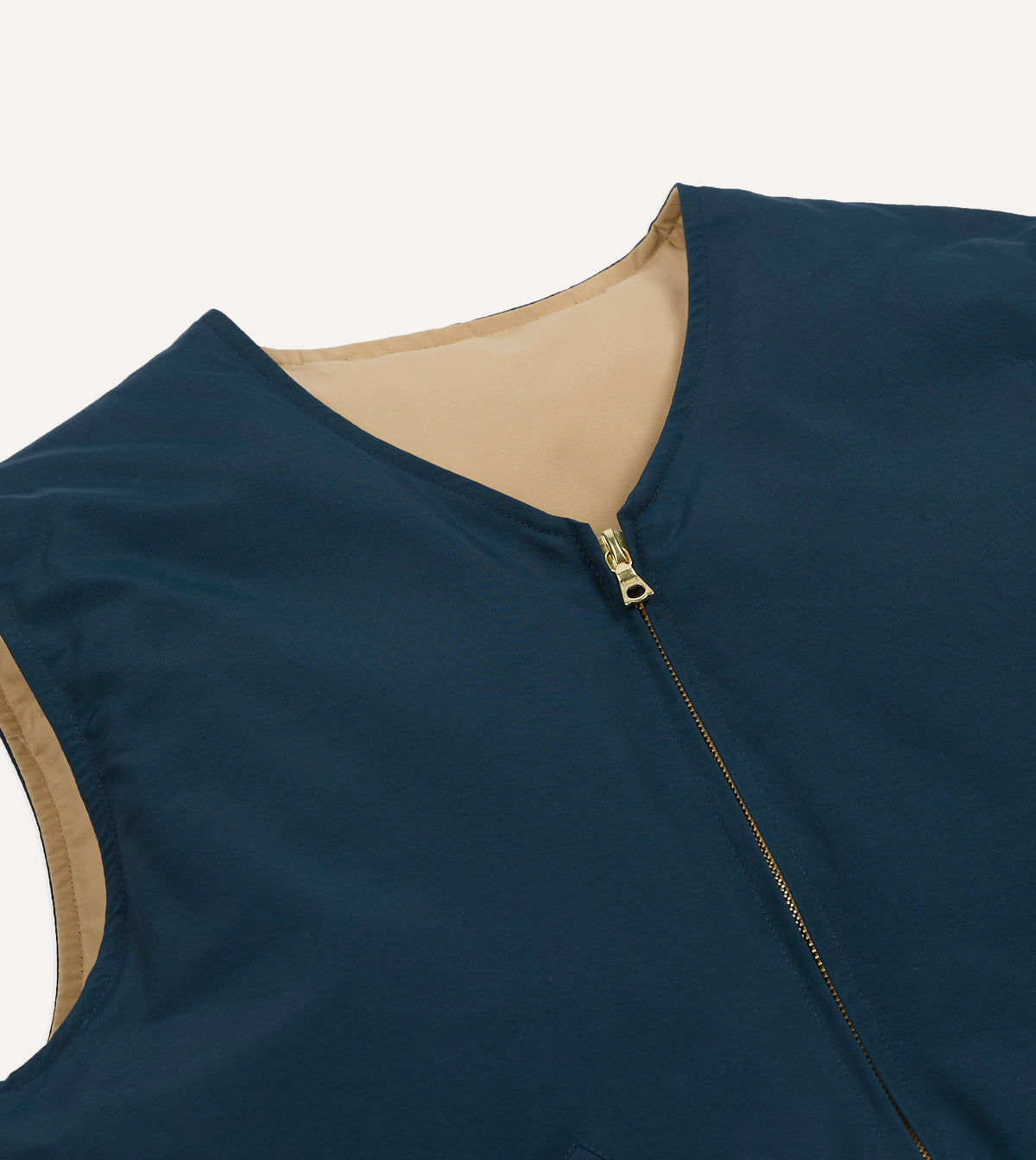Reversible down vest by Drake's in petrol and ecru, showing the quilted design and lightweight filling for outdoor wear.