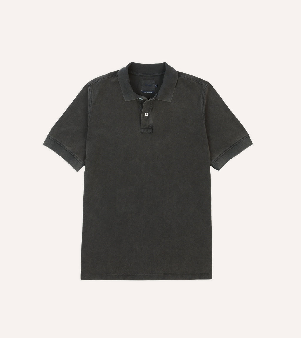 Drake's washed black pique cotton polo shirt, casual clothing with a classic collar and short sleeves, displayed on a white background.