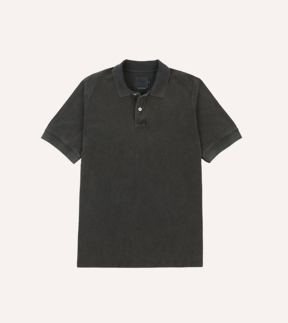 Drake's washed black pique cotton polo shirt, casual clothing with a classic collar and short sleeves, displayed on a white background.