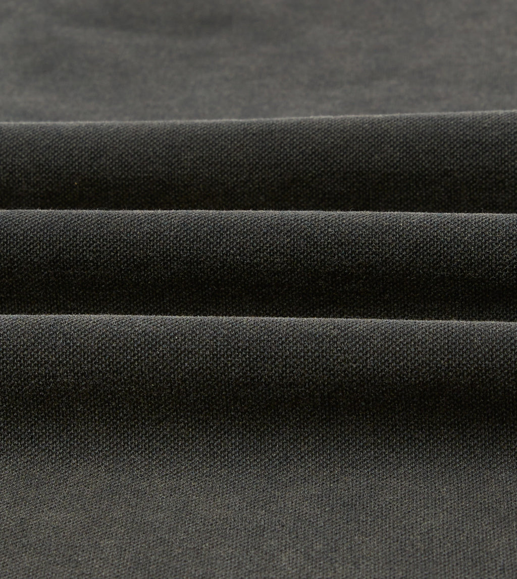 Drake's washed black pique cotton polo shirt, casual clothing with a classic collar and short sleeves, displayed on a plain background.