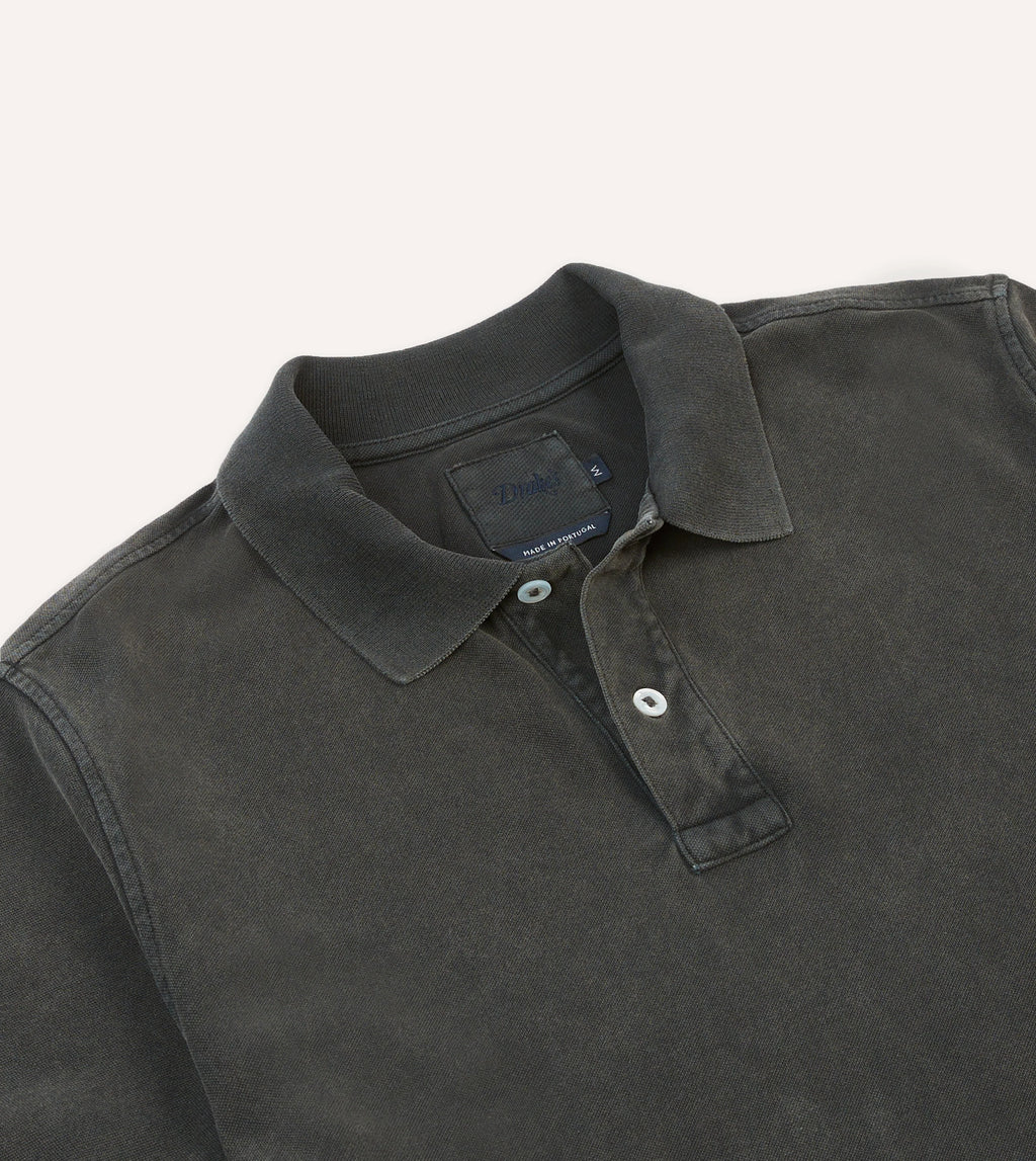 Drake's Piqué Cotton Polo in washed black, showing a classic collared shirt with textured fabric and button front.