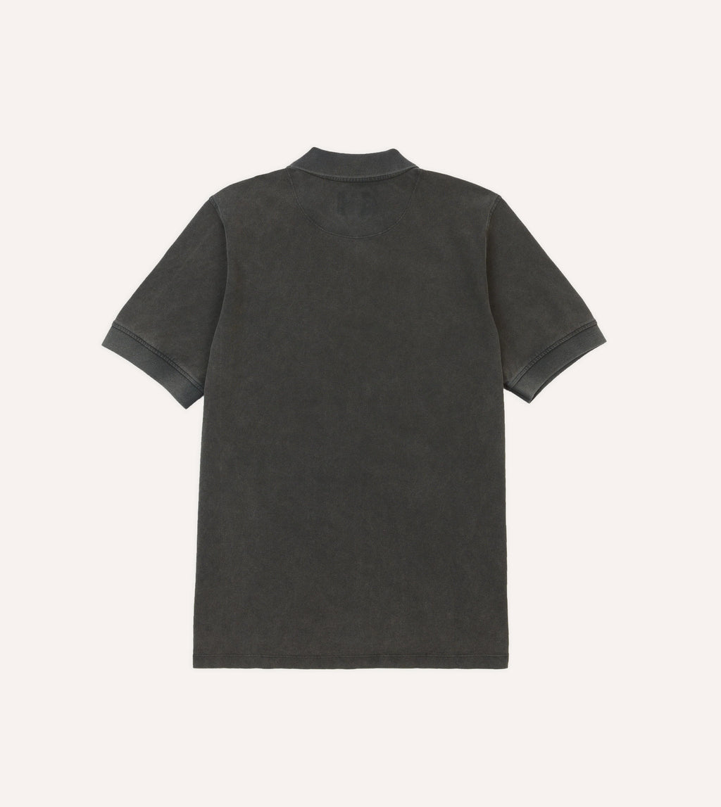 Drake's blackwashed cotton pique polo shirt displayed on a hanger, showcasing the classic collar and textured fabric.