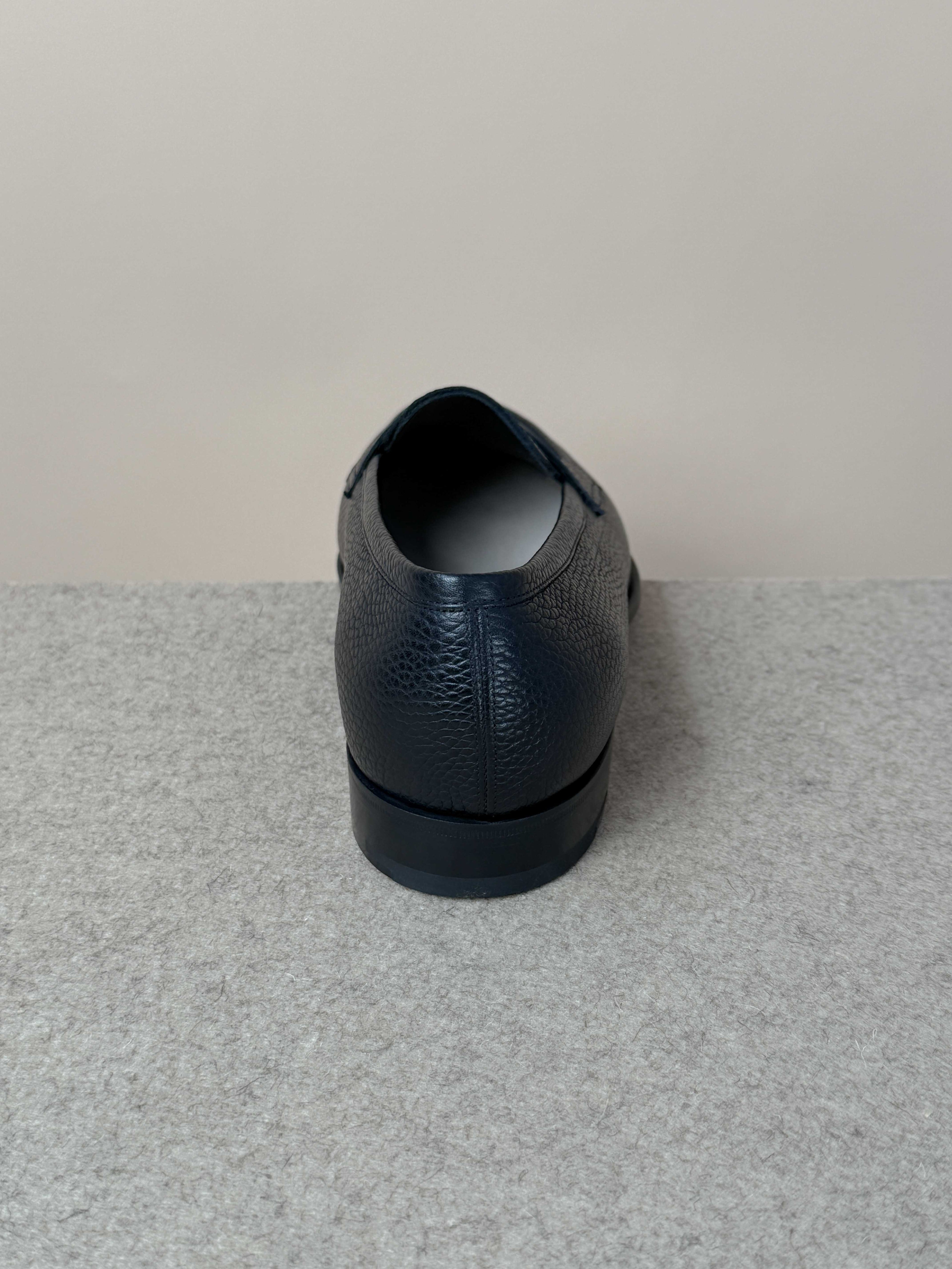 Edward Green Pimlico Penny Loafer in black Cotswold grain leather, showcasing classic slip-on footwear with a sleek design.