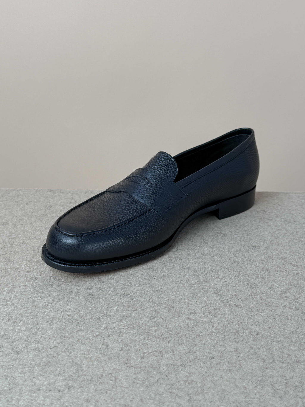 Edward Green Pimlico Penny Loafer in black Cotswold grain leather, showcasing classic slip-on design and fine craftsmanship.